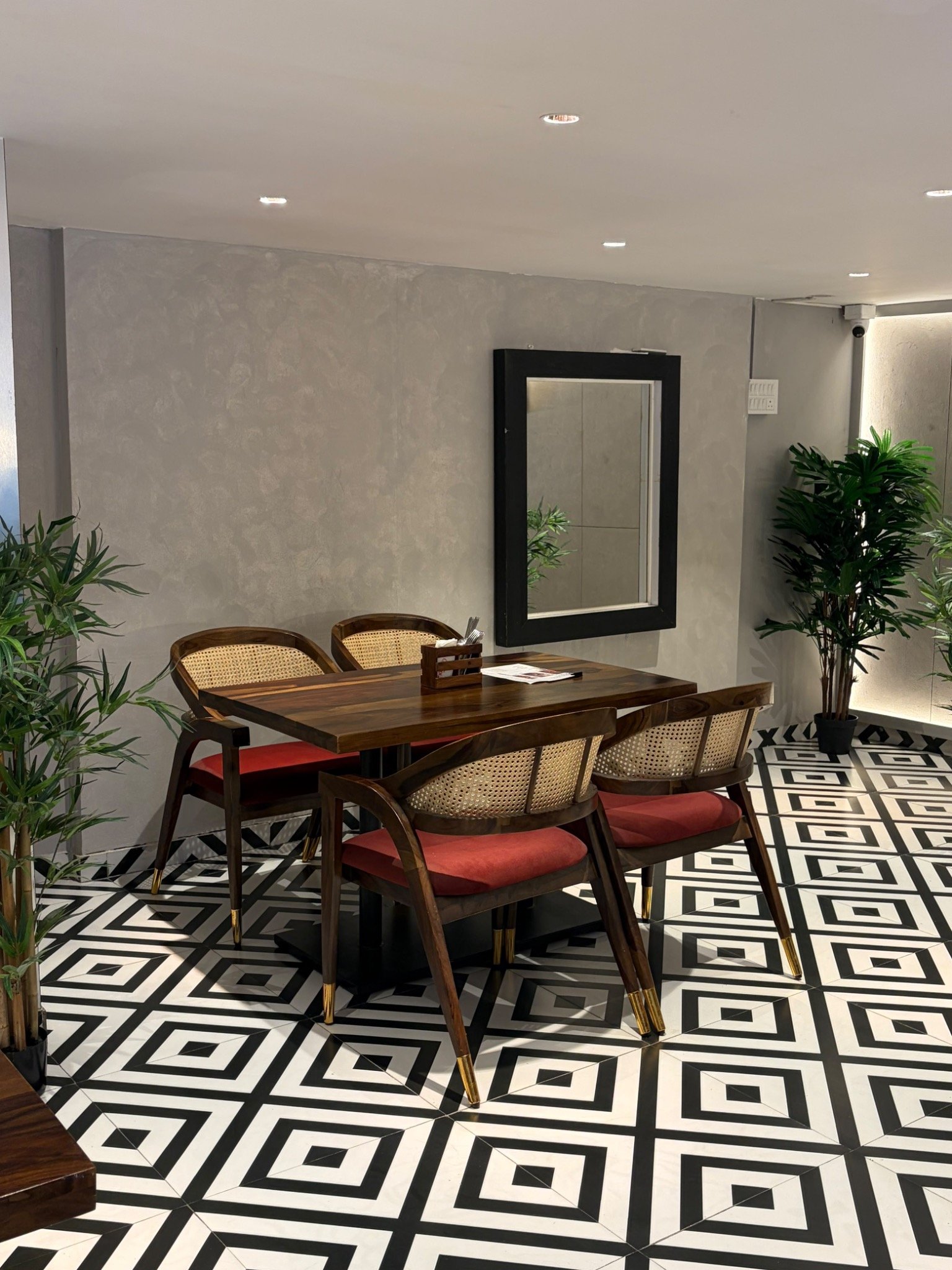 Four seater cafe table and cane chairs supplied by DYKU